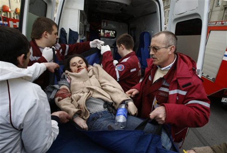 A wounded blast victim is brought by rescuers to an ambulance vehicle in Minsk, Belarus, on Monday, April 11, 2011. An explosion tore through a subway station in the Belarusian capital during evening rush hour Monday, and an official in the presidential administration said there were fatalities. 